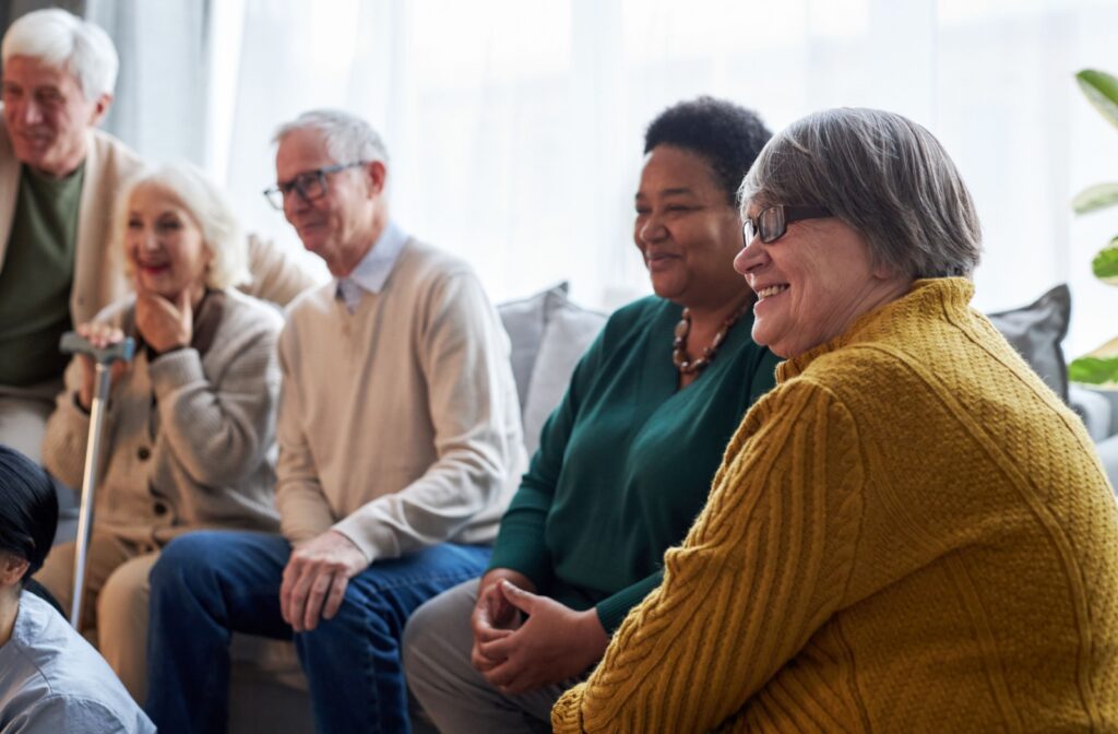 Smiling seniors sitting on a couch.